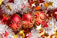 Festive Red Christmas Ornaments Surrounded by Glittering Decorations