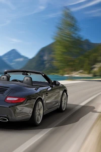 Sleek convertible cruising along a scenic mountain road.