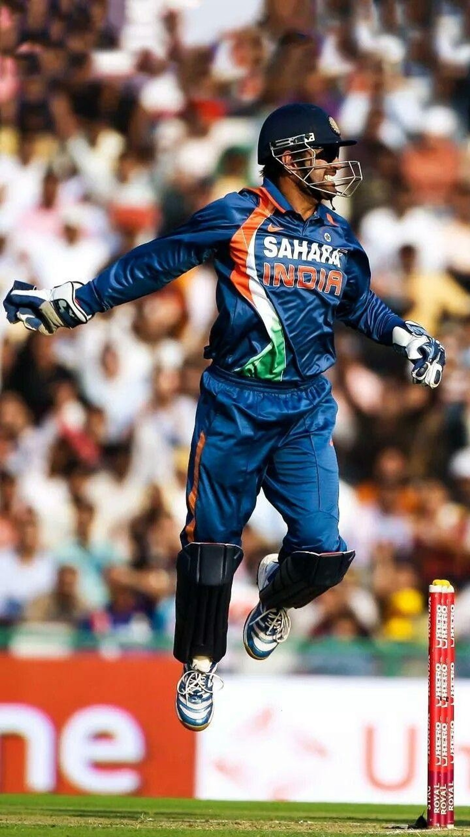 Arafed cricket player jumping to catch a ball during a game (cricket, dhoni, india, player, sports)