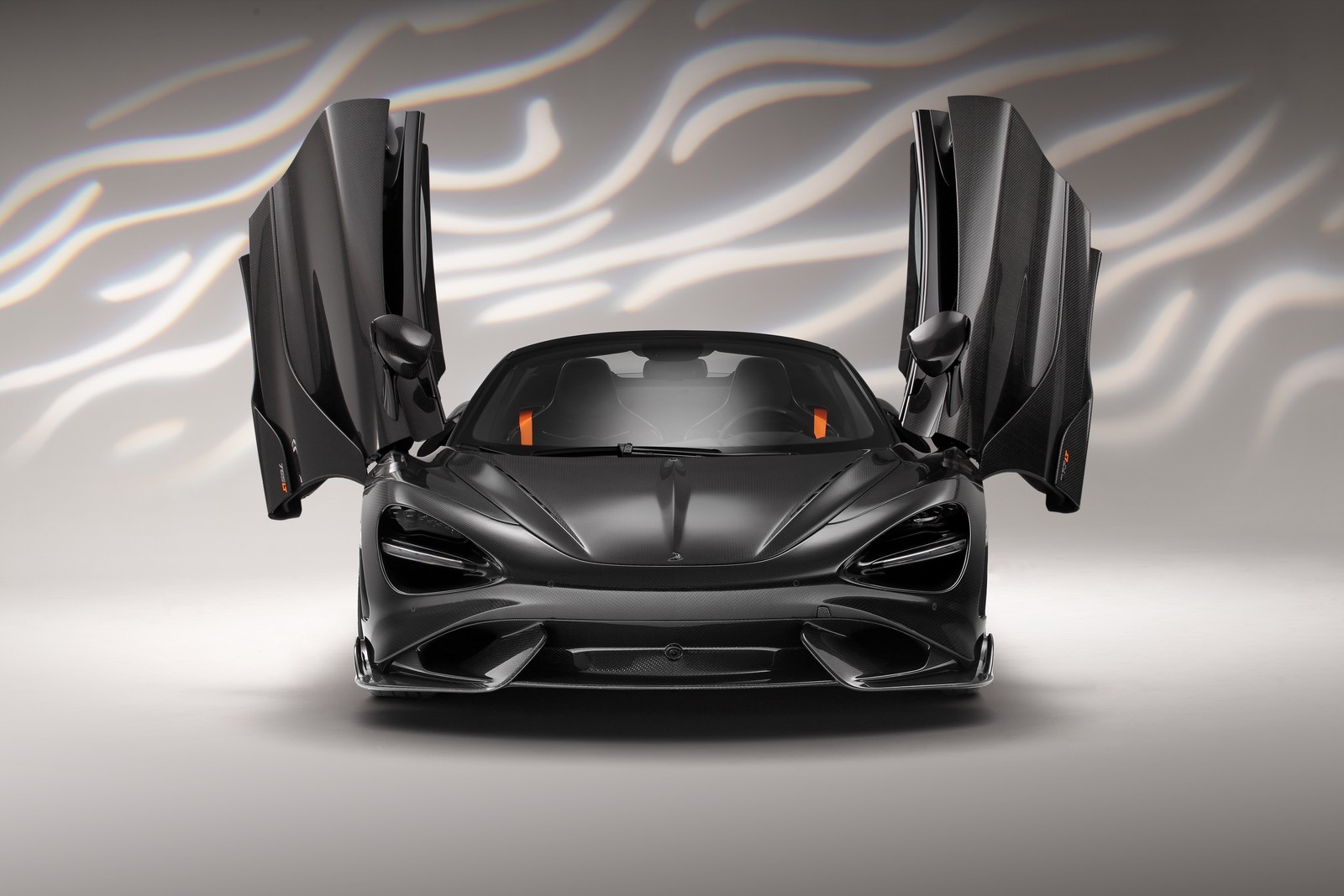 A black sports car with open doors and a zebra print background (topcar mclaren 765lt spider carbon edition, 2022, 5k, cars, 4k wallpaper)