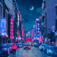 Nighttime Urban Scene in Akihabara with Skyscrapers, Bright Signage, and Cars