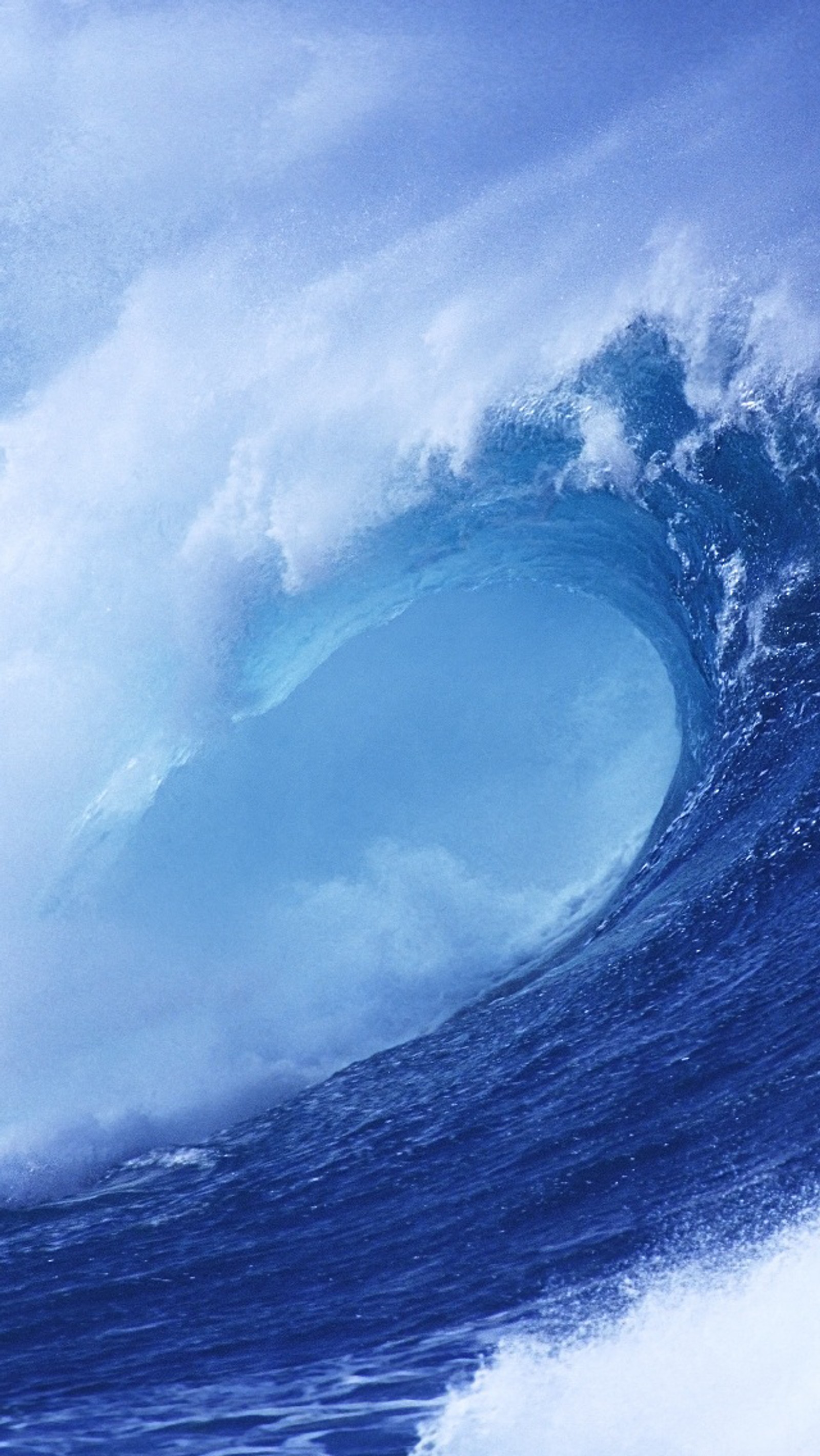 Surfer riding a large wave in the ocean on a blue day (ios 7, ios, wind wave, water, liquid)