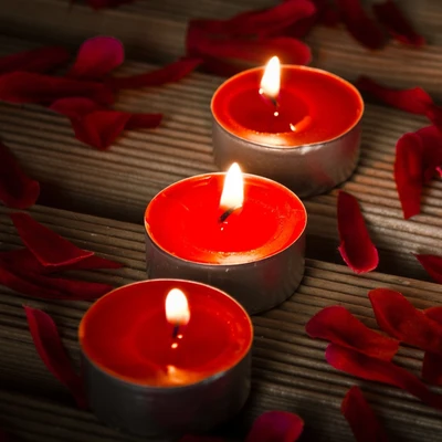 Red Candles Surrounded by Petals