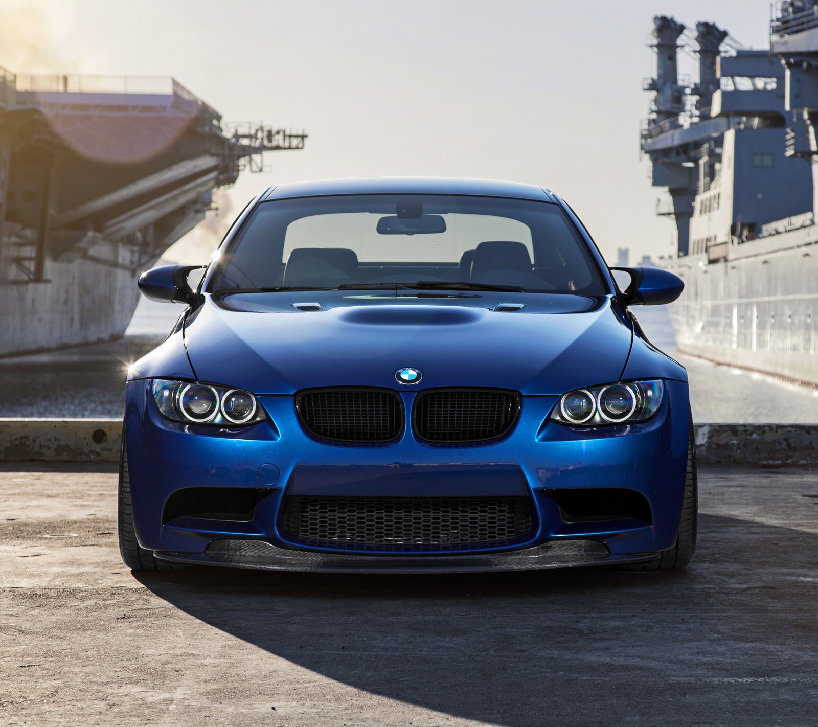 A close up of a blue bmw car parked in front of a ship (blue, bmw, coupe, e92, front view)