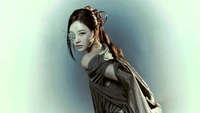 Ningning from Aespa in a captivating, ethereal pose, dressed in a flowing garment with a delicate accessory on her face.