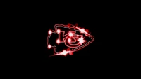 Kansas City Chiefs Logo with Sparkling Effects on Black Background