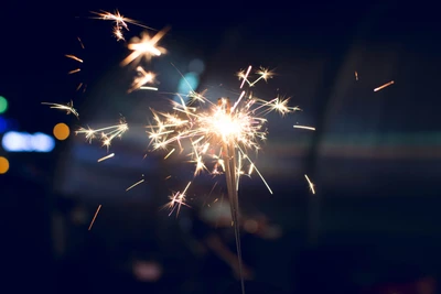 Nighttime Sparkler Celebration Amidst Festive Lights