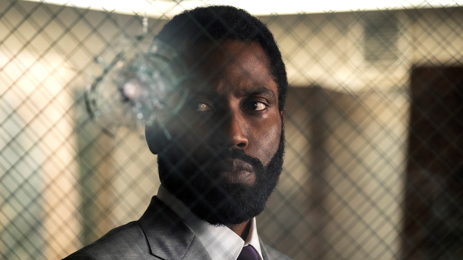 Arafed man in a suit and tie looking at the camera (tenet, 2020, movie, john david washington)