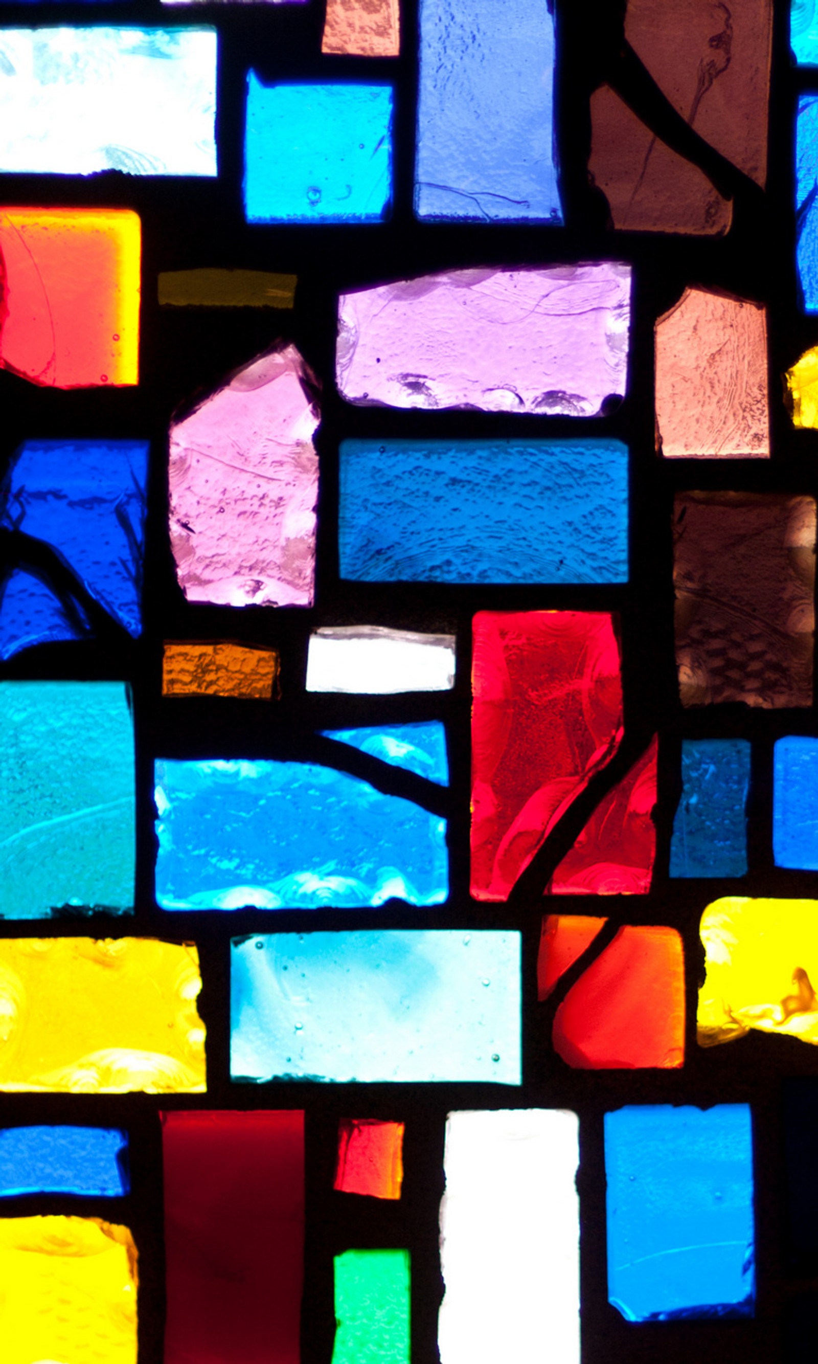 A close up of a stained glass window with a person in it (abstract, glass, stained)