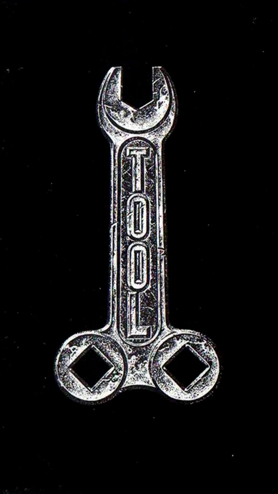 A polished wrench with the word "TOOL" etched on its handle, set against a black background.