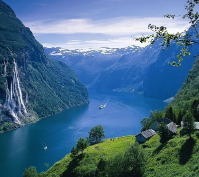 Serene Lake Surrounded by Majestic Mountains Under a Clear Sky