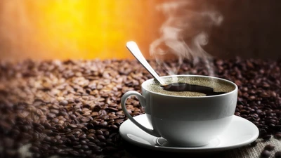 Steaming Cup of Rich Espresso Surrounded by Coffee Beans