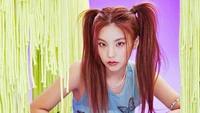 Yeji de ITZY posant avec des couettes ludiques sur un fond vibrant, incarnant la confiance et le style.