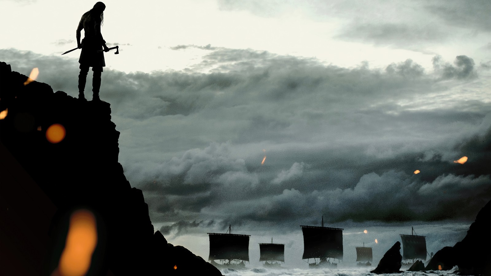 There is a man standing on a cliff with a sword (the northman, movie, 2022)