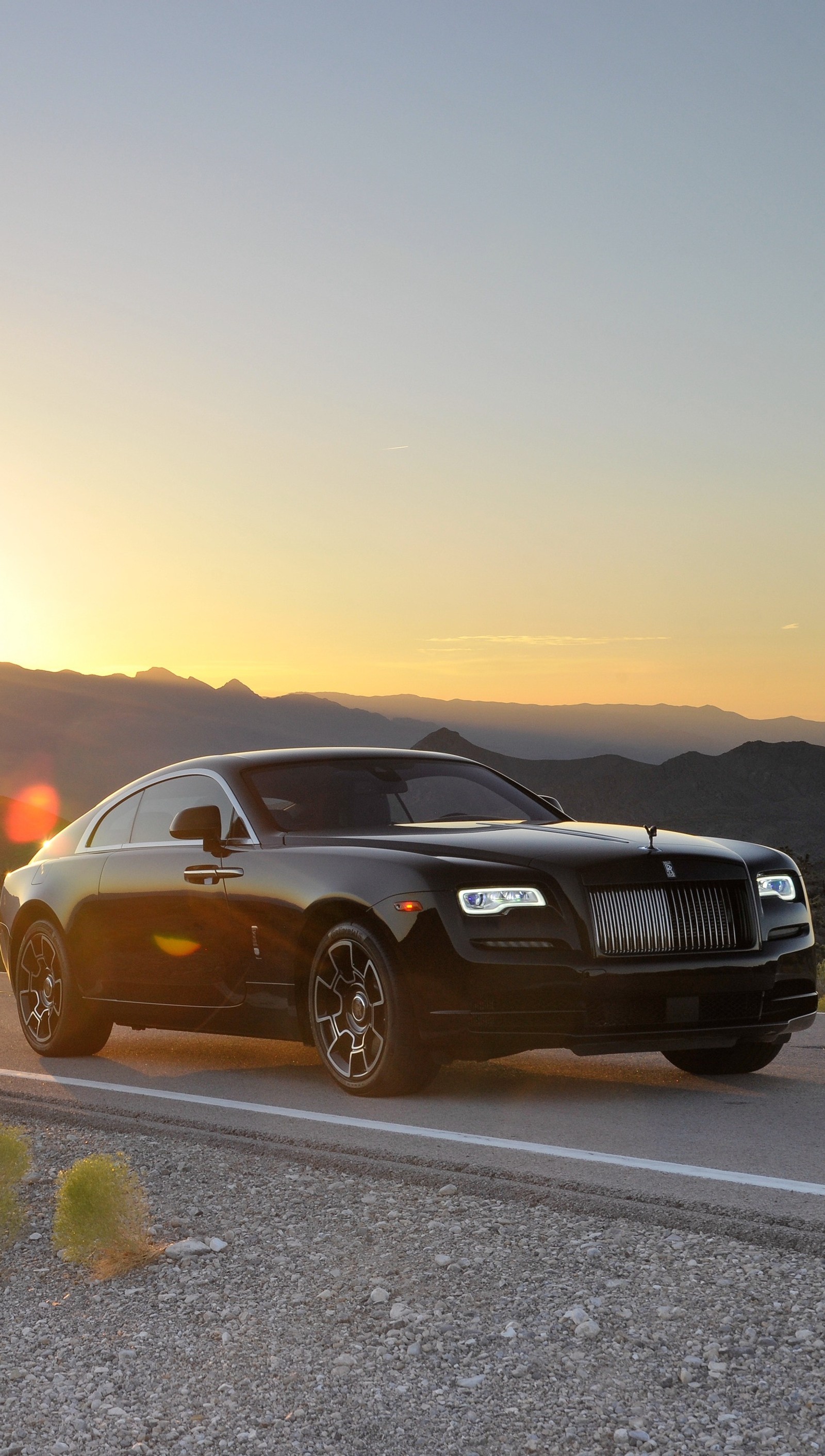 Arafed rolls royce car on a road with mountains in the background (black, car, rolls, royce)