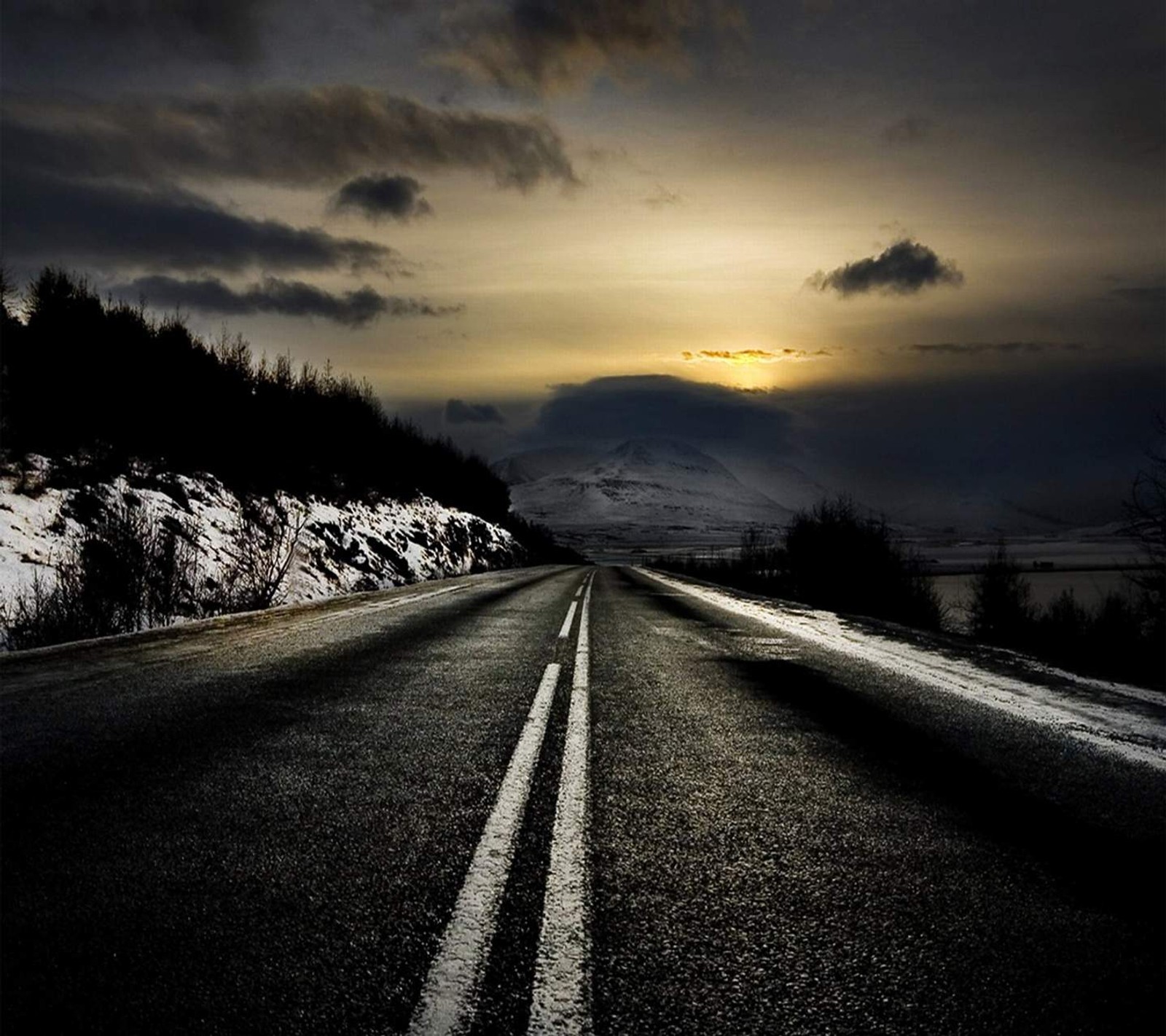 A close up of a road with a sky background and a mountain in the distance (alandscape, nature, road, sunset)