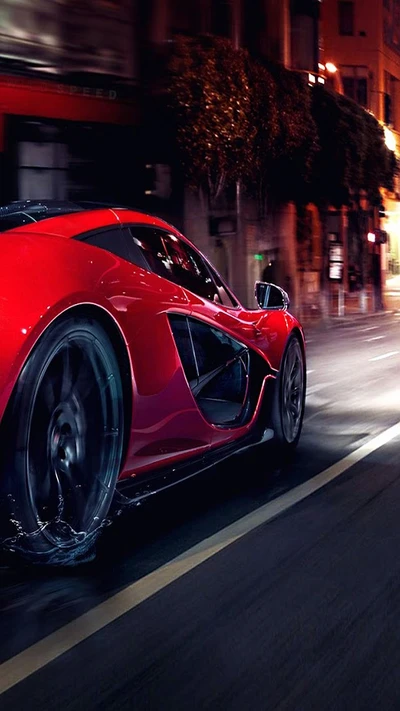 Voiture de sport rouge dynamique roulant à travers une ville la nuit