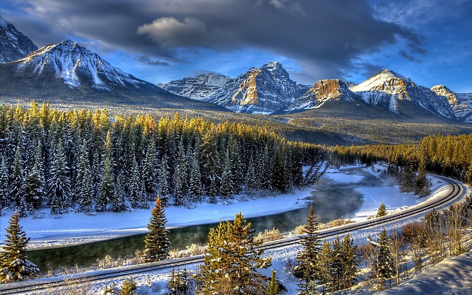 Mountains and trees are covered in snow and snow on the ground (natural landscape, mountain, nature, mountainous landforms, wilderness)