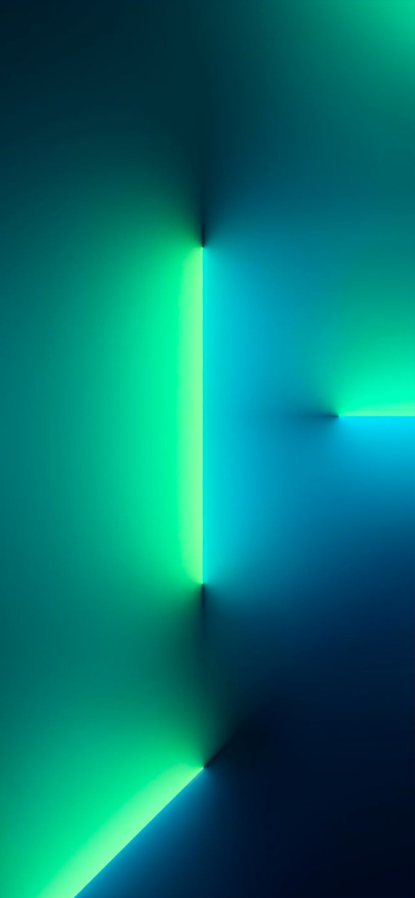 A dimly lit room with a green and blue light (apples, apple, iphone, ios 15, iphone 13 pro and iphone 13 pro max)