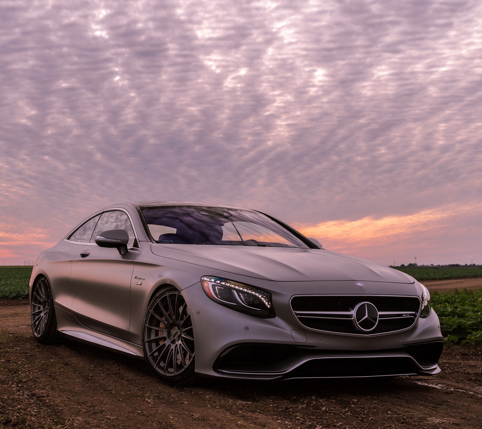 A close up of a car parked on a dirt road (auto, car, mercedes)