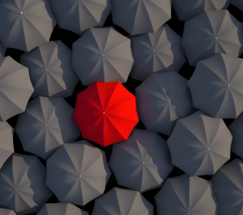 A close up of a red umbrella surrounded by many gray umbrellas (black, red, umbrellas)