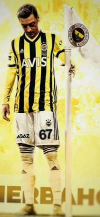 Mesut Özil in Fenerbahçe's iconic yellow and black kit, standing by a corner flag with a focused demeanor.