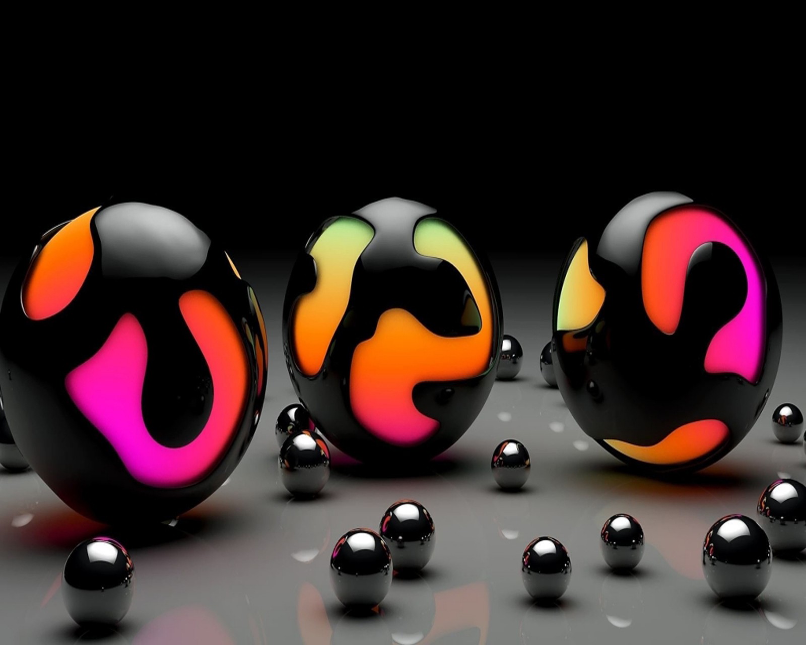 Three black spheres with colorful swirls are sitting on a surface (balls, three)