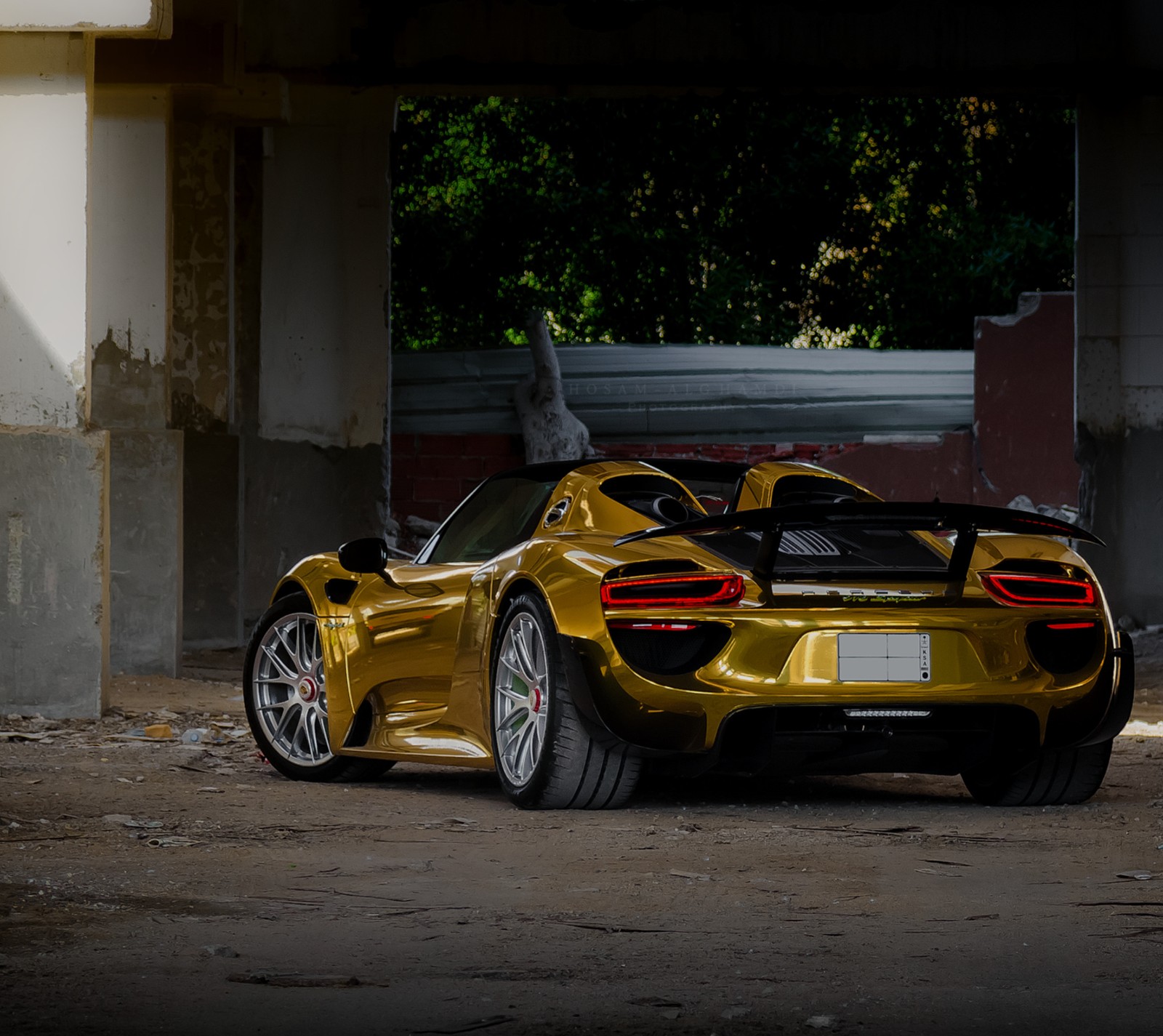 A close up of a yellow sports car parked in a garage (918, edition, gold, porsche)