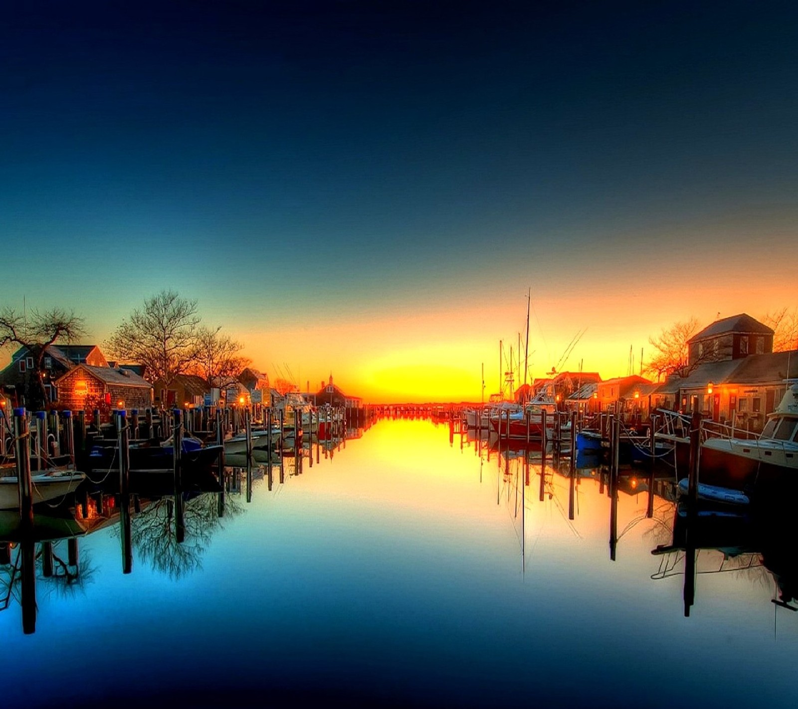 Boats are docked at a marina at sunset with a colorful sky (nature)