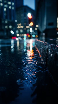 Reflections of City Lights on Rainy Asphalt