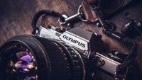 Olympus Single Lens Reflex Camera with Lens on Wooden Surface