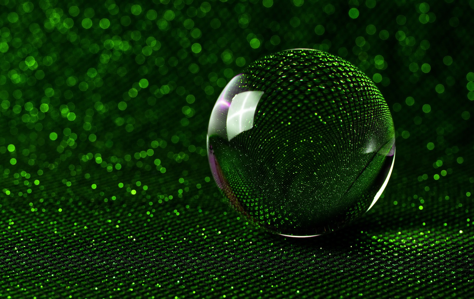 A close up of a glass ball on a green background (crystal ball, green aesthetic, bokeh background, 5k, macro)