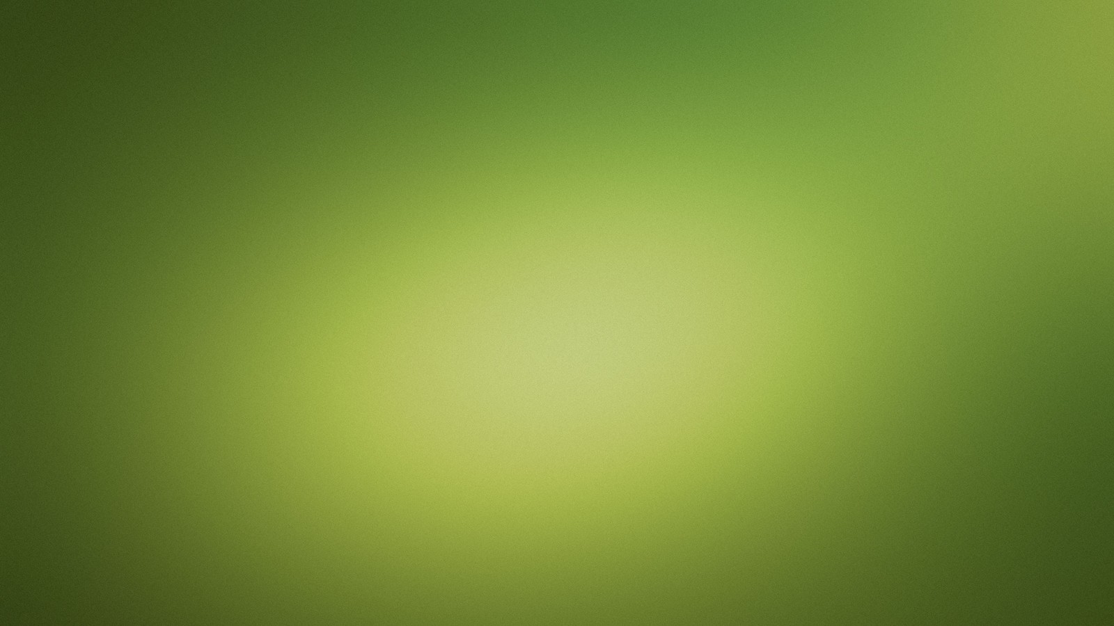 There is a blurry image of a green background with a red stop sign (green, grass, atmosphere, grasses, sky)