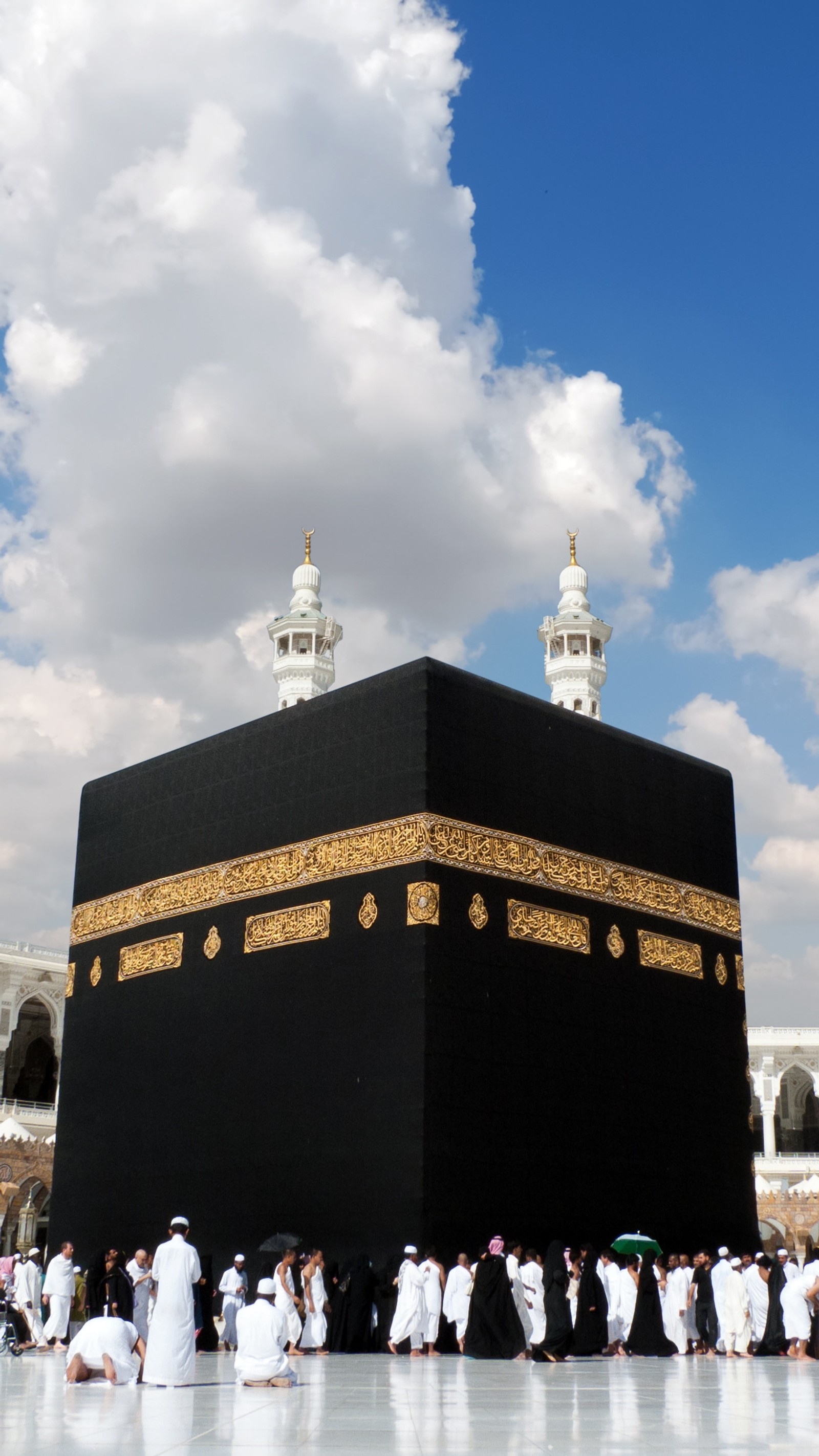 Muslim people standing around a black building with a clock tower (islam, kaaba, kaabah, makkah, masjidil haram)