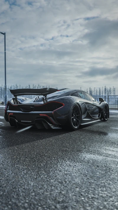 McLaren P1 in a sleek black finish, showcased on a winter road under a cloudy sky.