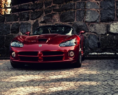 Dodge Viper rouge frappant contre un mur en pierre rustique