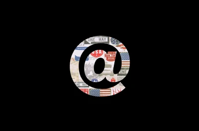 Stylized '@' symbol featuring a collage of American imagery and text, set against a dark background, representing digital communication and branding.