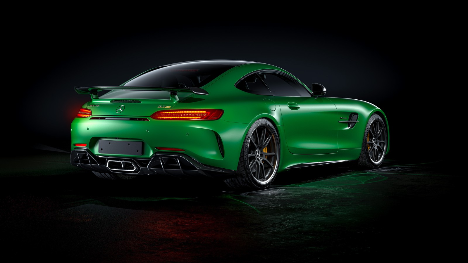 The rear end of a green mercedes sports car in a dark room (car, sports car, supercar, coup, mercedes amg)