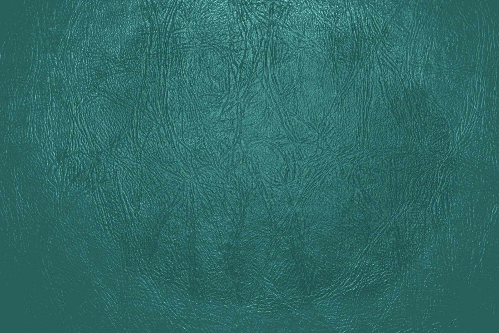 Un gros plan d'une texture en cuir vert avec un léger motif (texture, vert, aqua, bleu, turquoise)