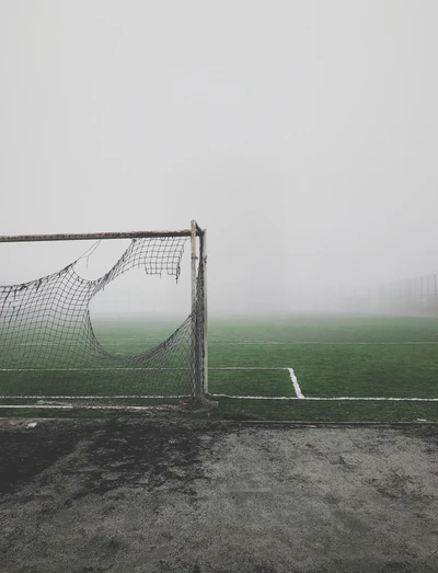 Foggy Soccer Field with Goalposts