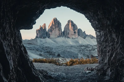 Majestic Mountain Peaks Framed by Natural Arch in Serene Park