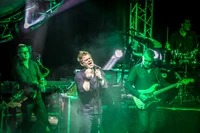 Electric Energy: Captivating Live Performance Under Green Lights