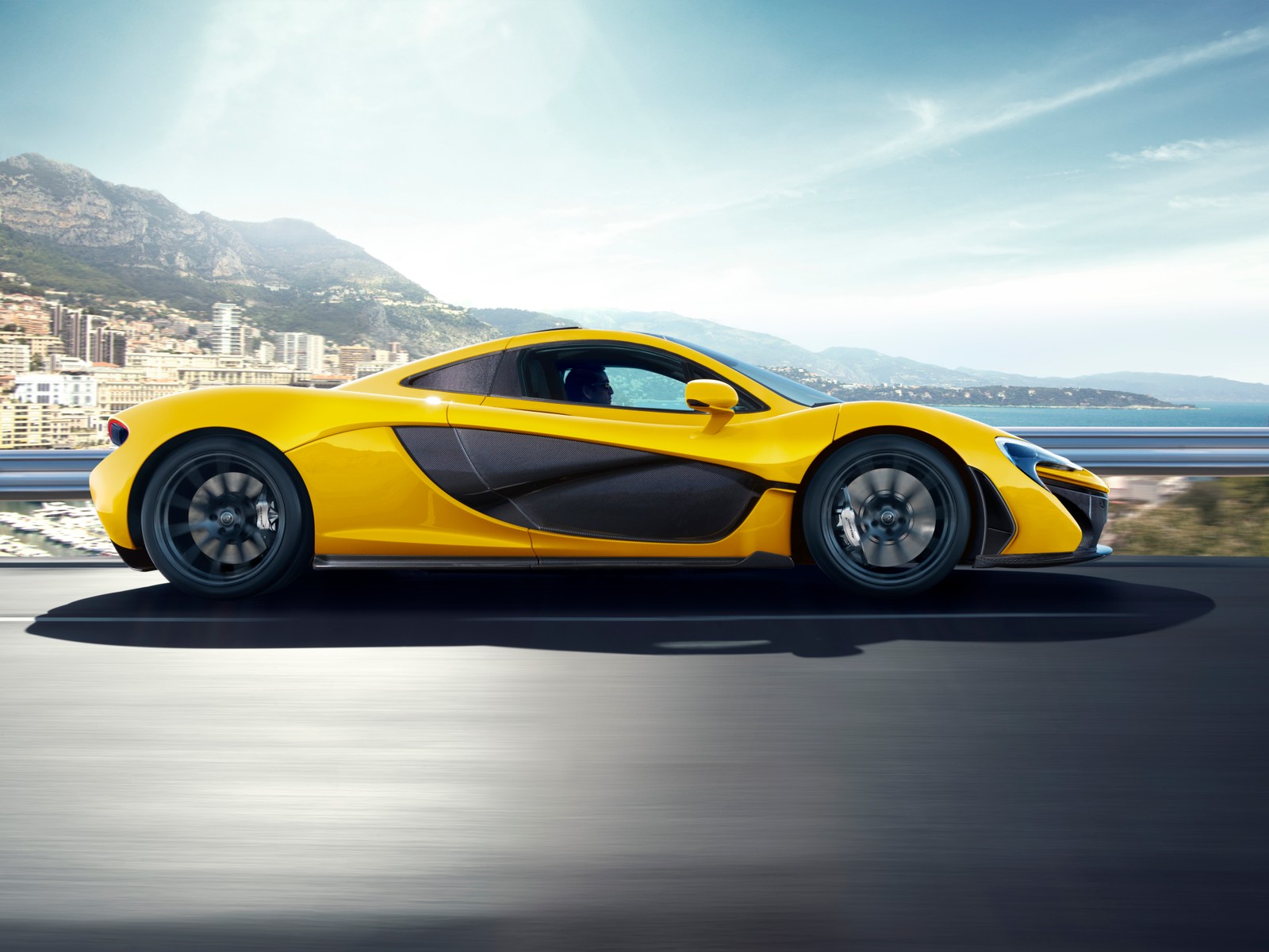 The mclaren 911 supercar is shown driving on a road (mclaren automotive, mclaren, sports car, car, laferrari)