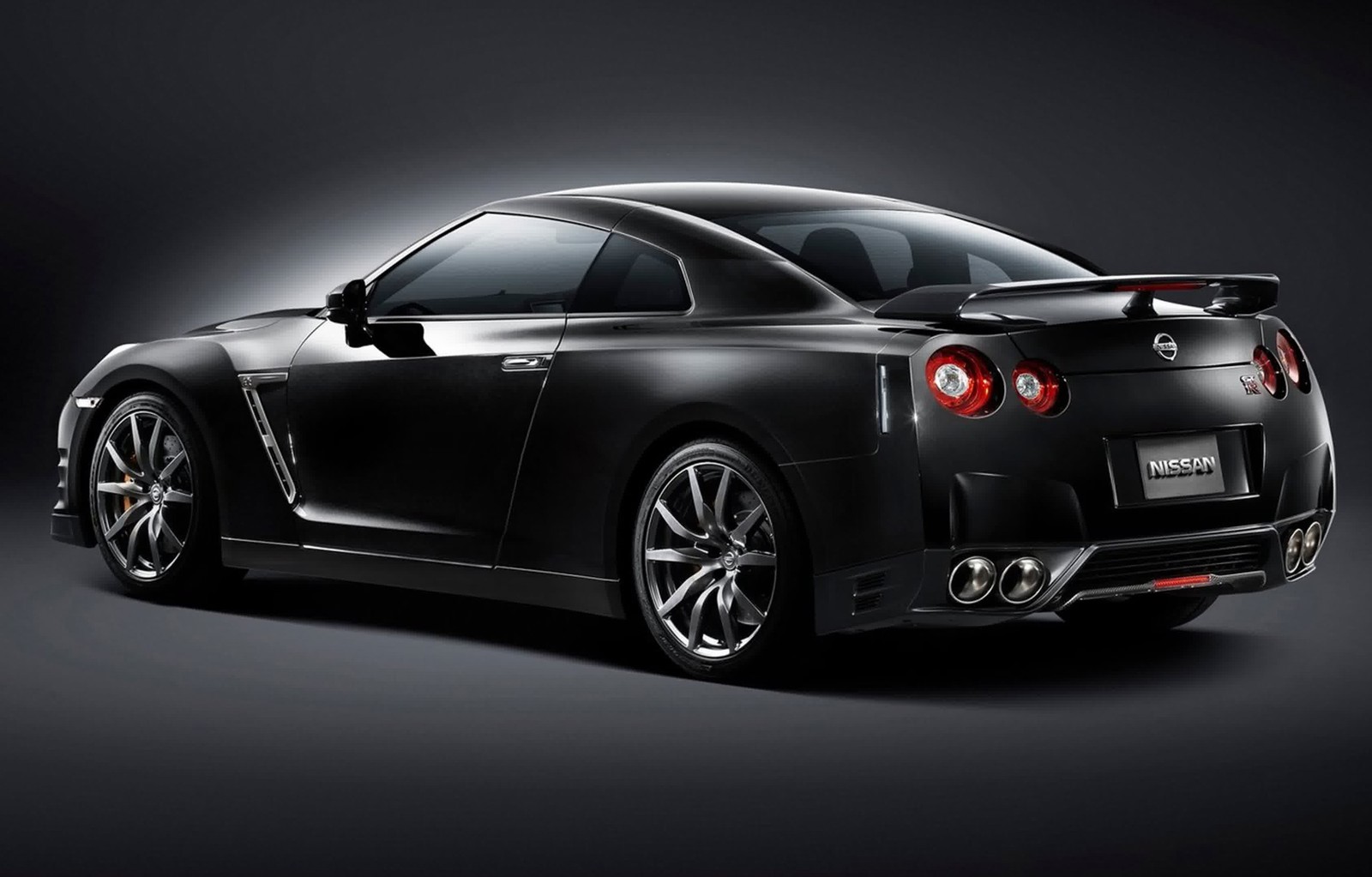 A black nissan sports car is shown in a studio setting (2015 nissan gt r, sports car, nissan, car, supercar)