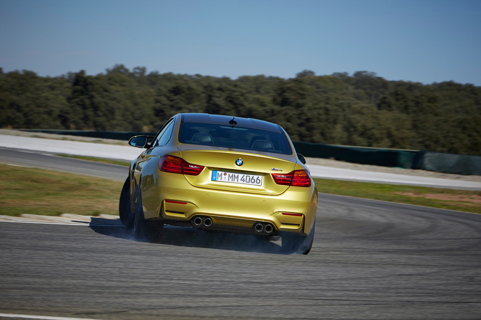 Une voiture bmw jaune roulant sur une piste avec des arbres en arrière-plan. (bmw, voiture de sport, voiture, voiture de luxe, bmw m3)