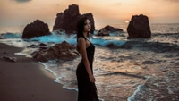 Elegance by the Ocean: A Lady in Black Gown Embracing Nature's Beauty