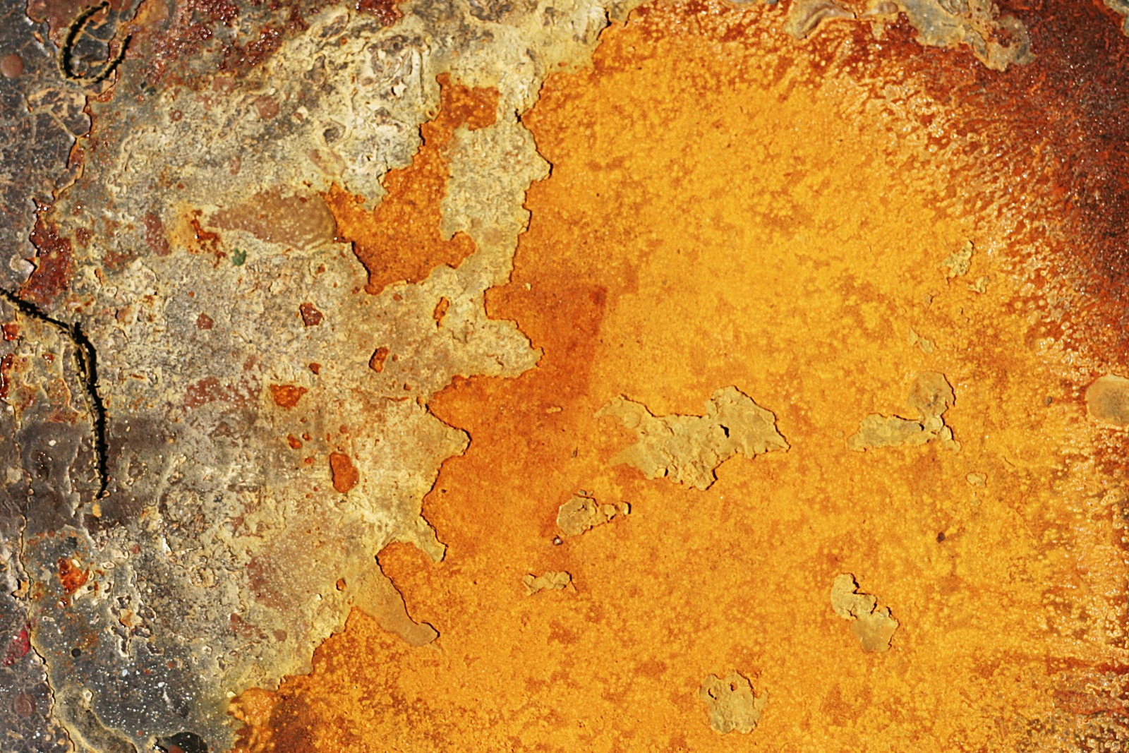 A close up of a rusted surface with a yellow substance (rust, metal, design, yellow, orange)