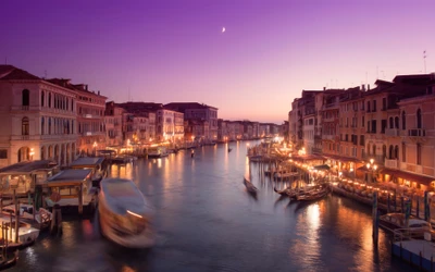 Enchanting Venice at Sunset: Serene Waters and City Lights under a Purple Sky