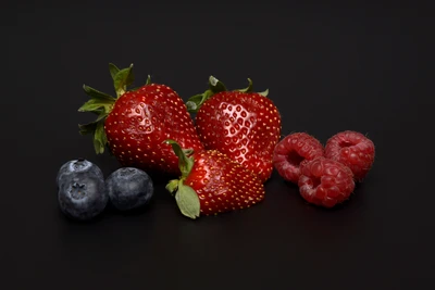 Fresh Strawberries, Raspberries, and Blueberries on Black Background