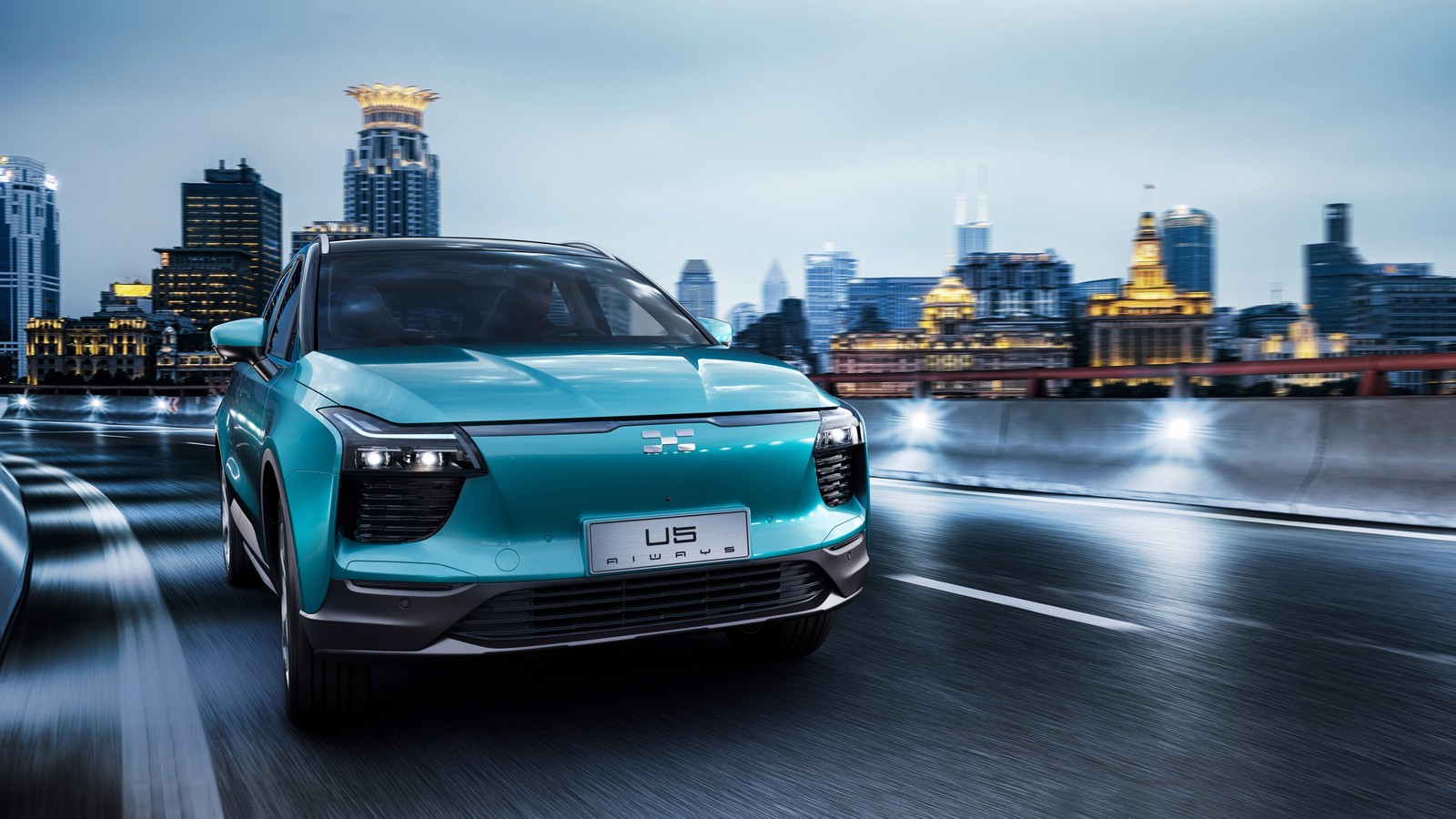 A blue suv driving down a city street at night (geneva motor show, cars, audi e tron, seat, cloud)